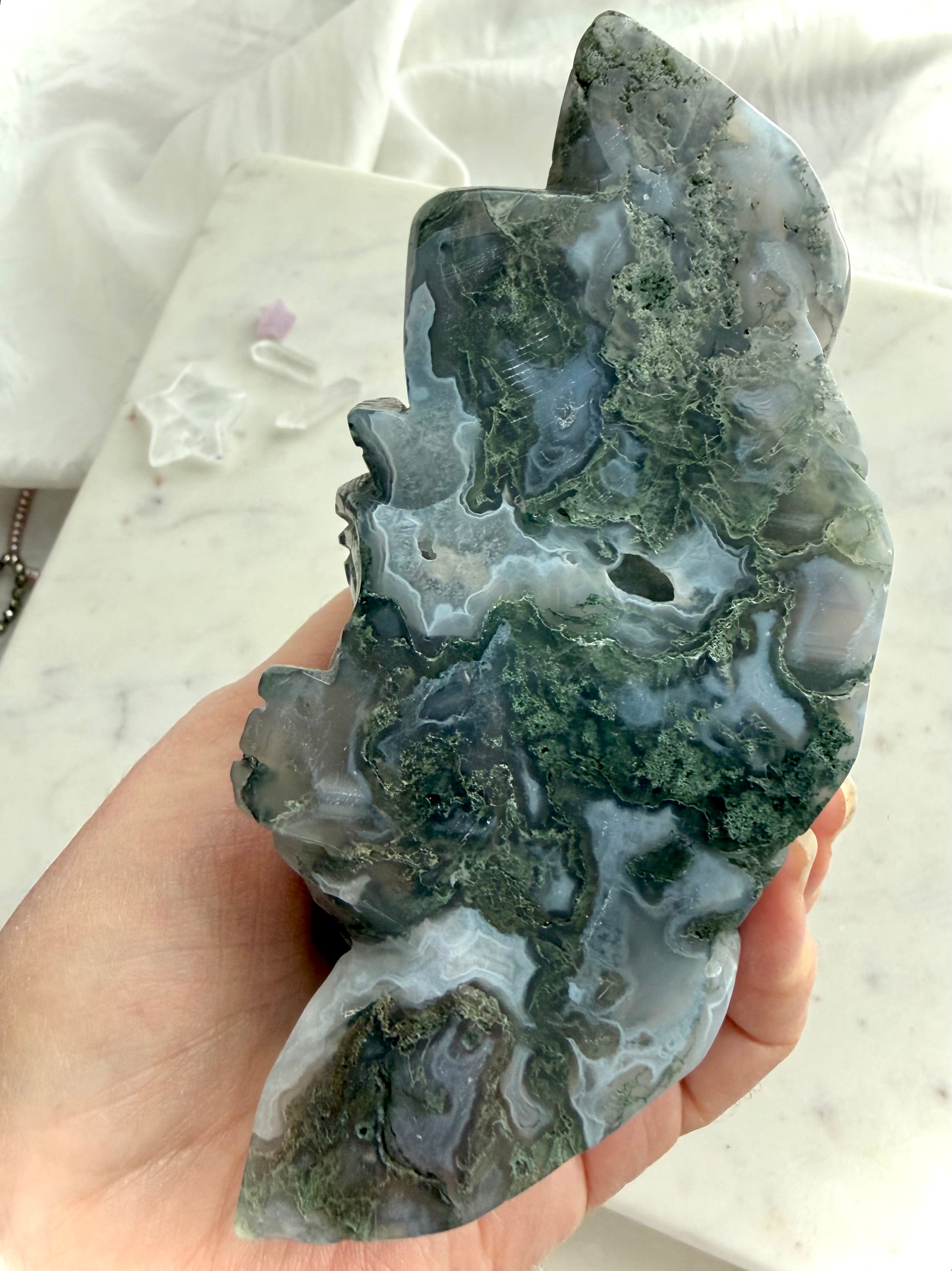 Underside and back of a Large Moss Agate Laughing Buddha carving showing natural Moss Agate patterns