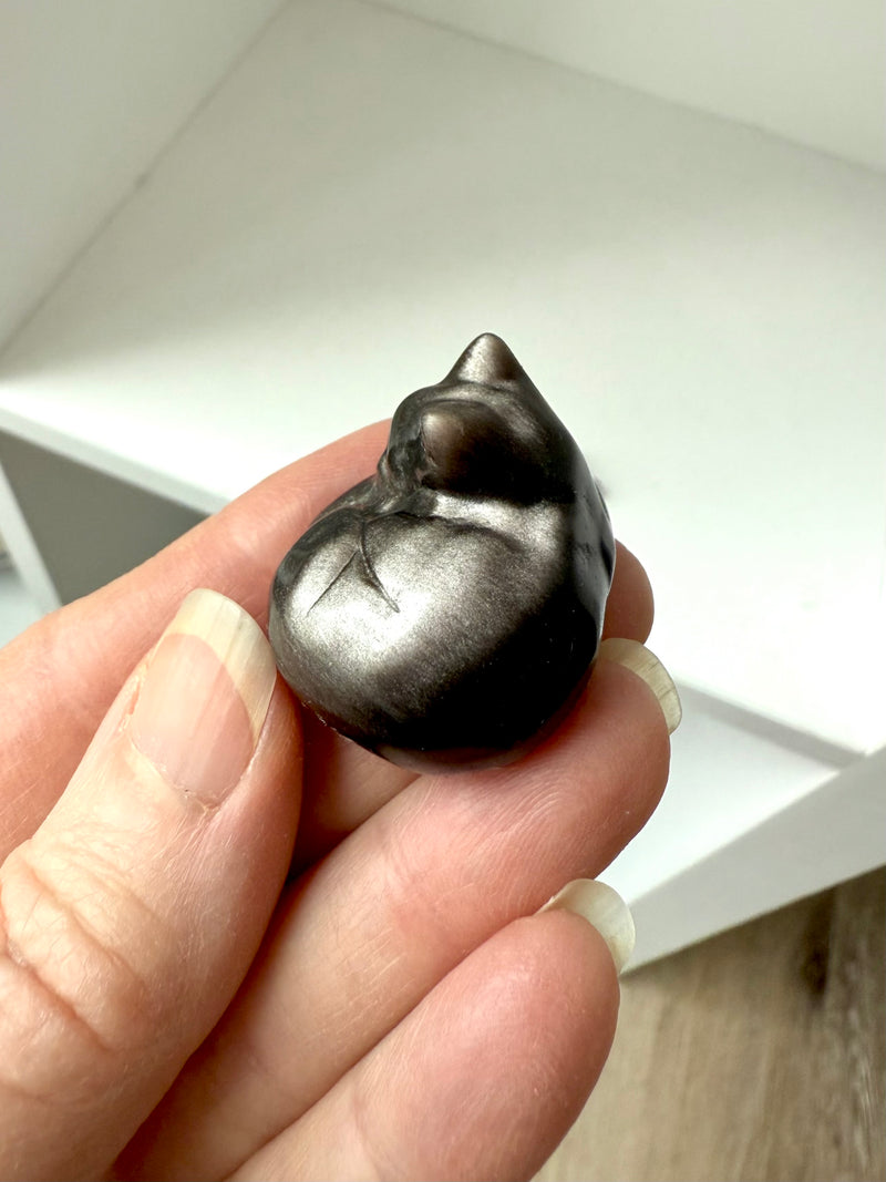 This mini Silver Sheen Obsidian Sleeping Cat carving has lots of shimmer