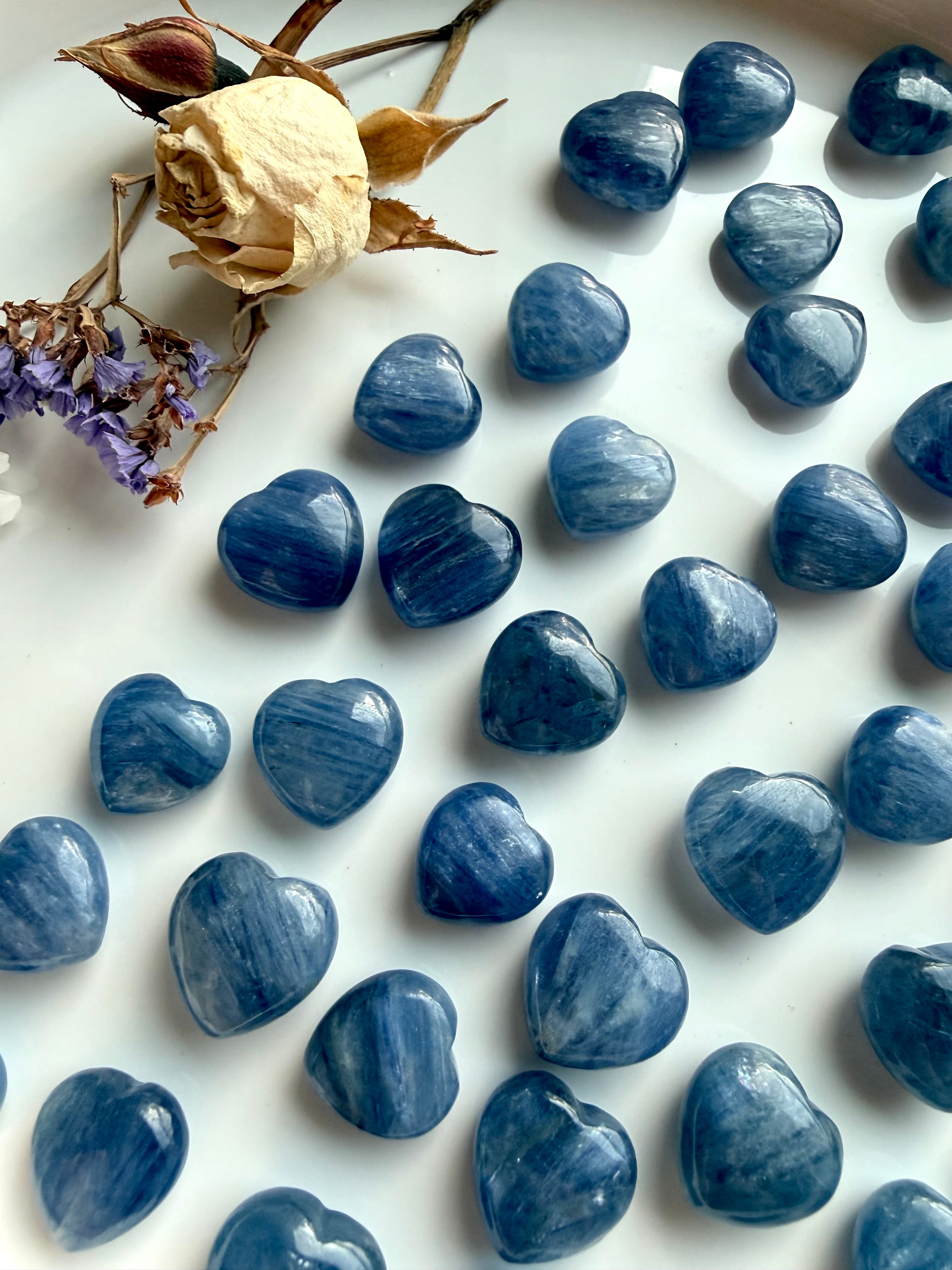 Assorted mini Blue Kyanite crystal hearts in various sizes with natural variation in color, shimmer and inclusions