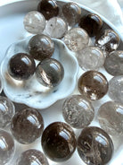 Smoky Quartz mini spheres with translucent grounding crystal tones and polished glossy finish