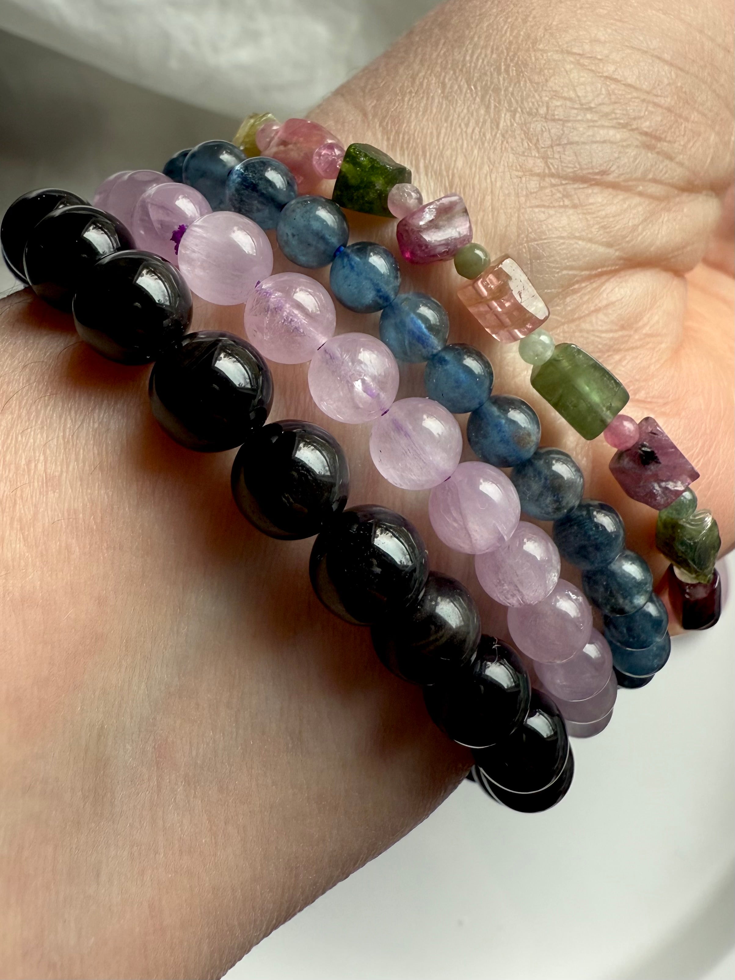 Our Rainbow Tourmaline Cube Bracelet worn with black tigers eye, lilac kunzite + devil aquamarine