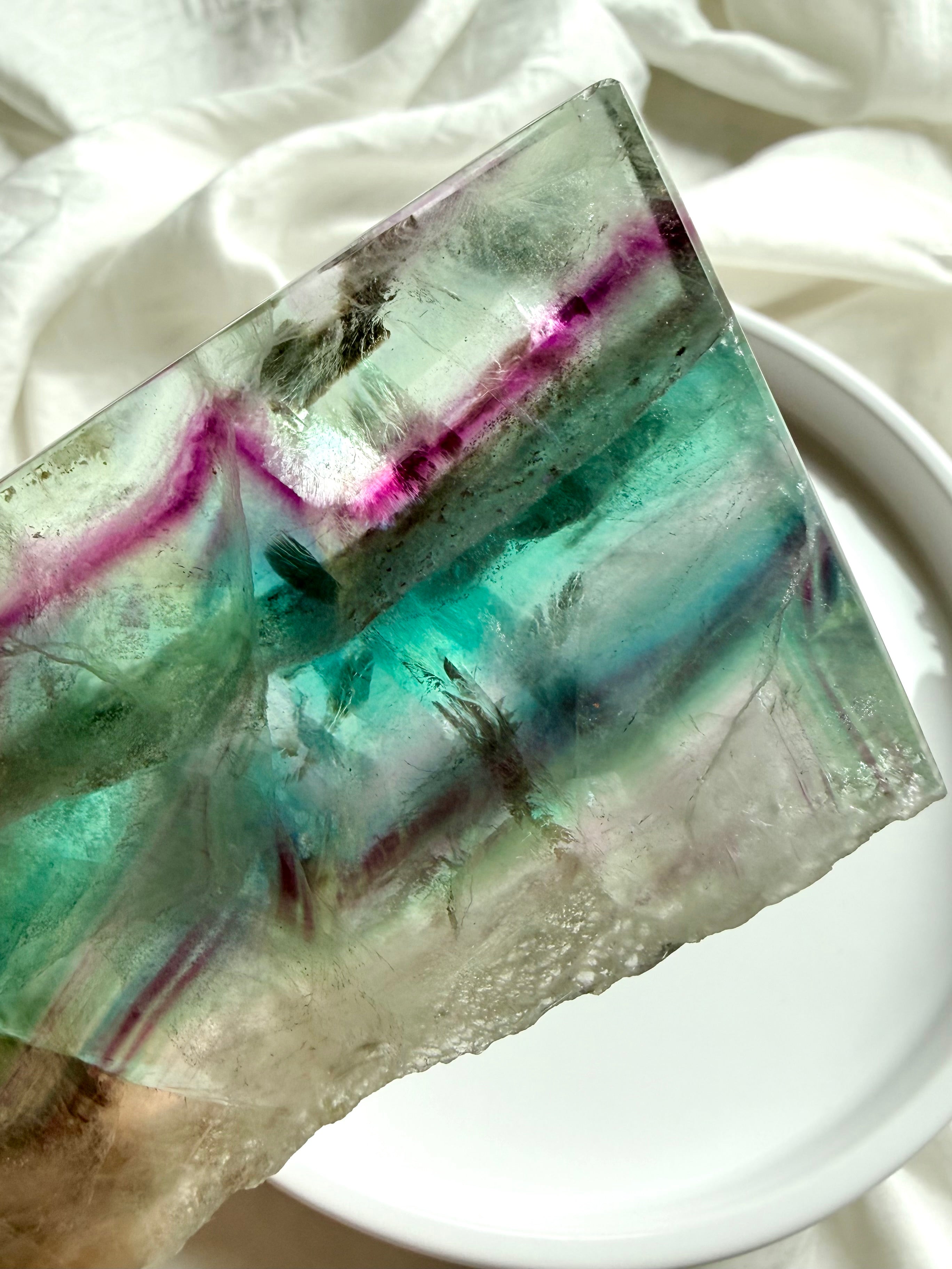 Close-up of natural fluorite slab showing layered color zoning and polished crystal surface