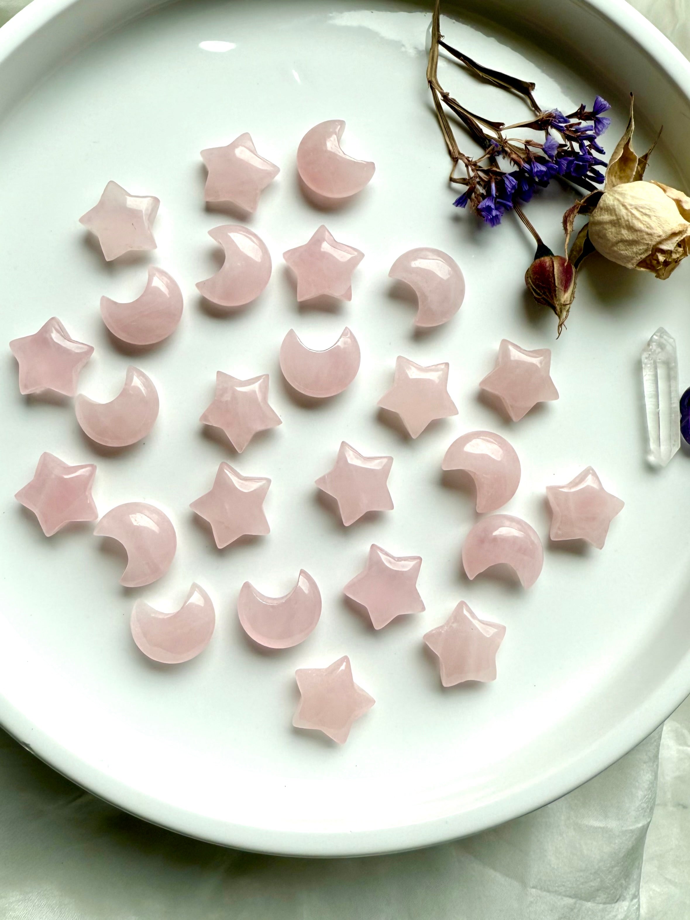 Flatlay of mini Rose Quartz moons &amp; stars. Mini crystal carvings for love, guidance, and Heart Chakra healing.