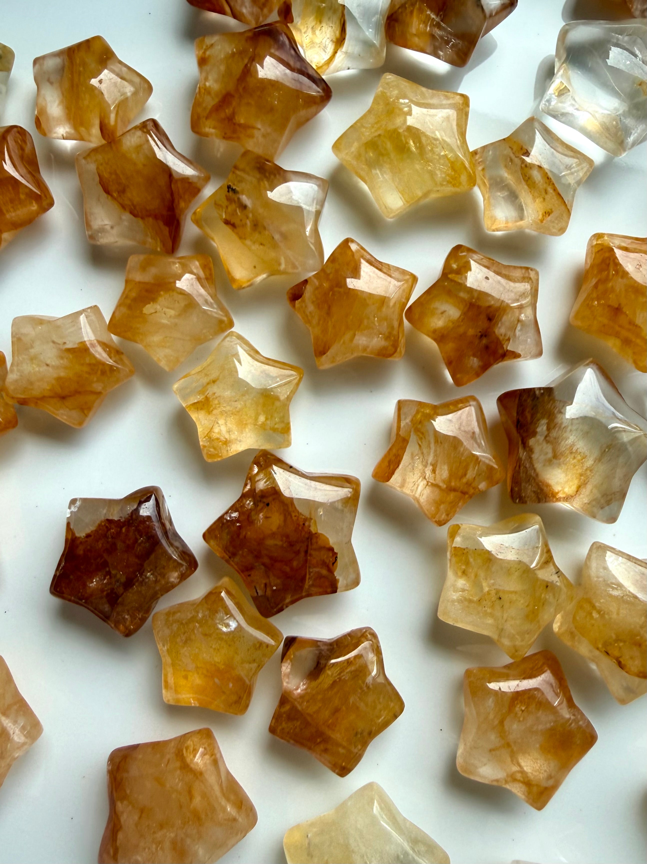 Golden Healer Quartz star carvings arranged together for crystal grids, meditation, and sacred spaces