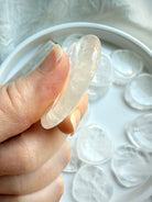 clear quartz heart worry stone side view showing thickness and smooth finish