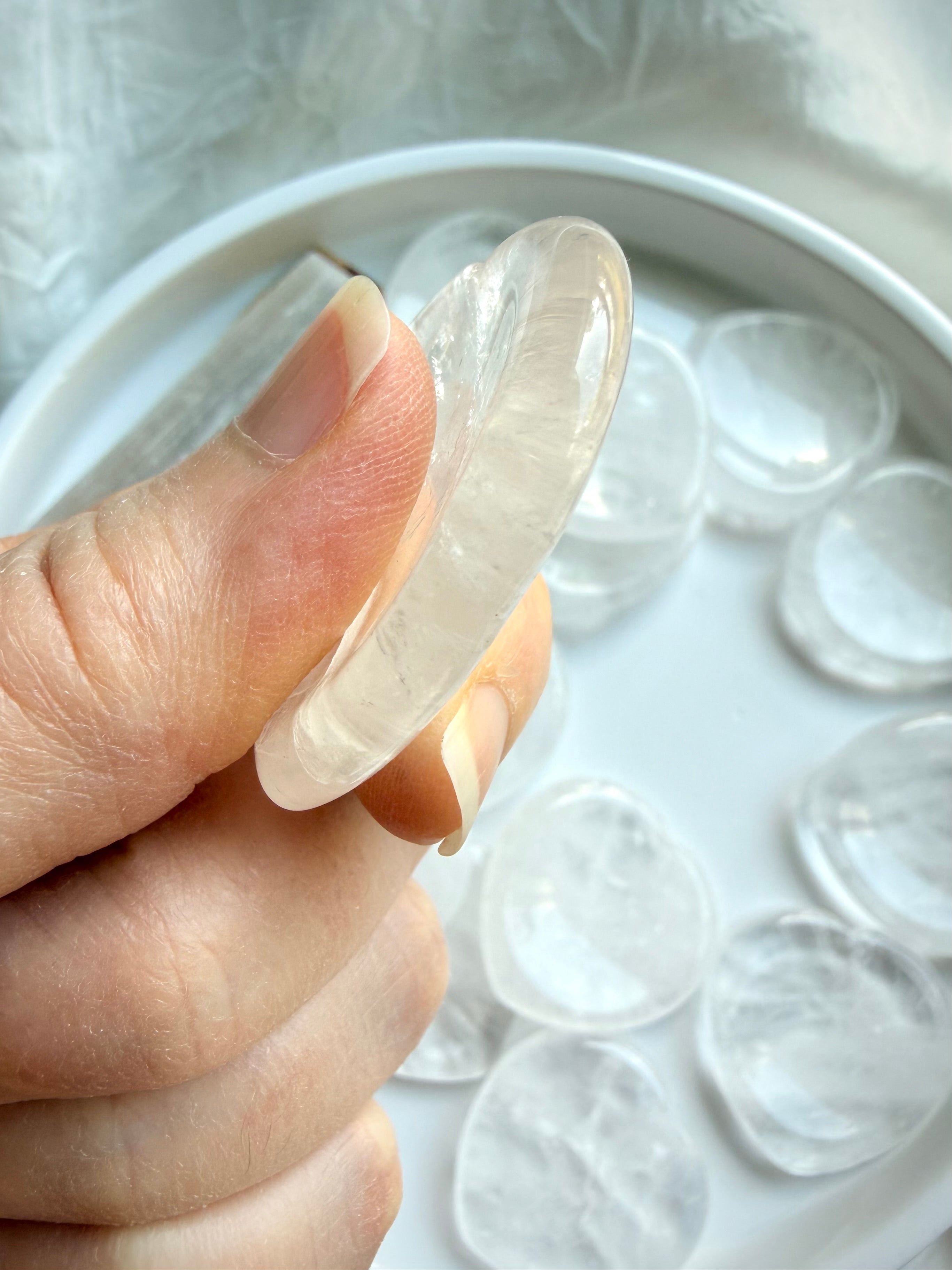 clear quartz heart worry stone side view showing thickness and smooth finish
