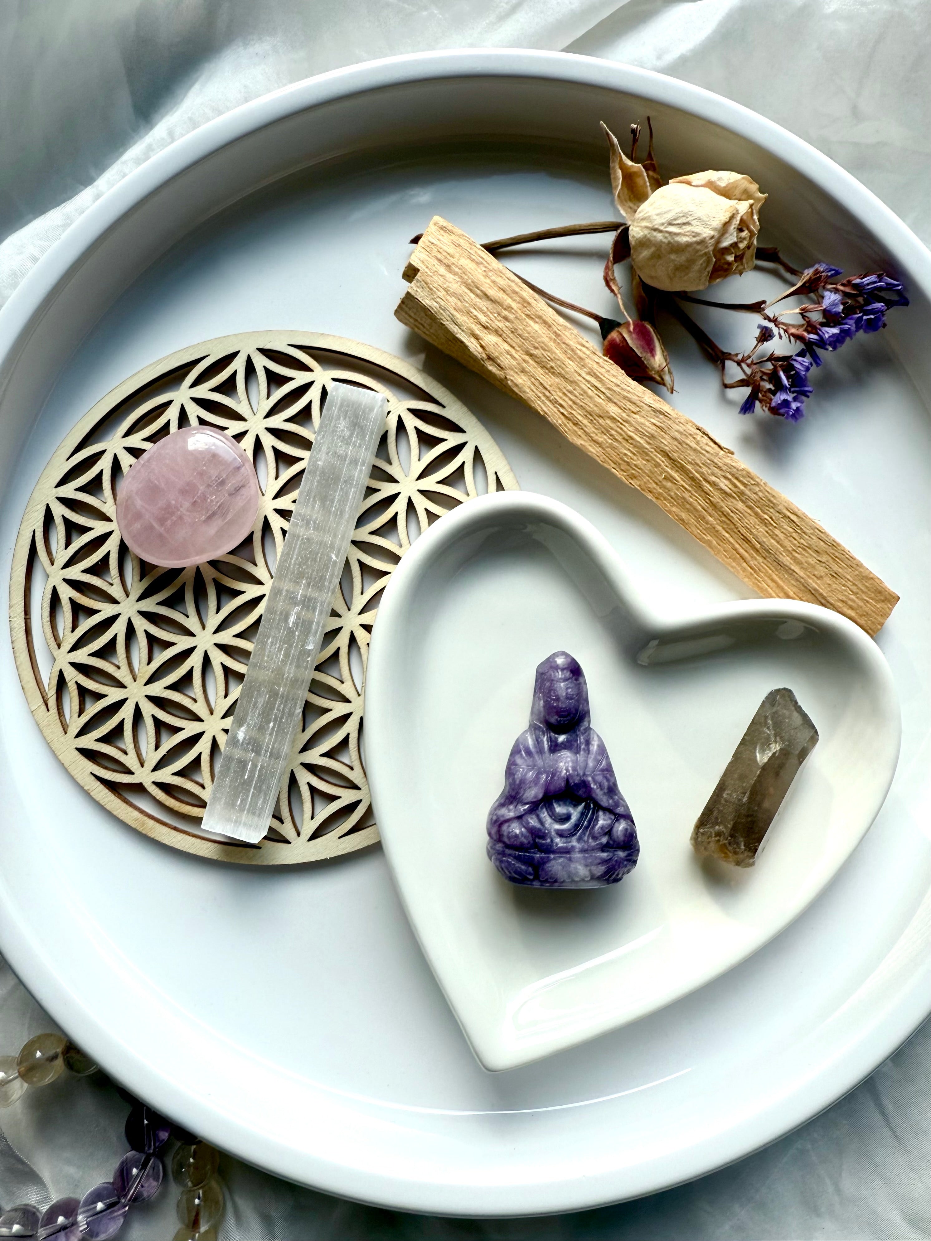 Lepidolite Quan Yin carving with rose quartz, smoky quartz, palo santo, selenite + dried flowers in heart dish on altar tray – crystal gift set for peace and spiritual healing