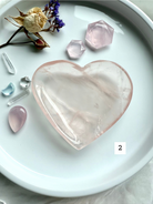 rose quartz heart bowl styled with dried flowers and polished crystals, a heart chakra offering dish for love, healing energy, and spiritual décor