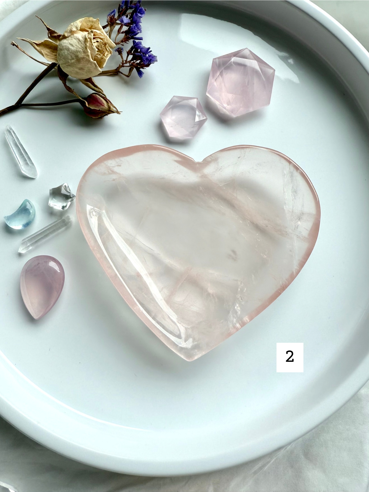 rose quartz heart bowl styled with dried flowers and polished crystals, a heart chakra offering dish for love, healing energy, and spiritual décor