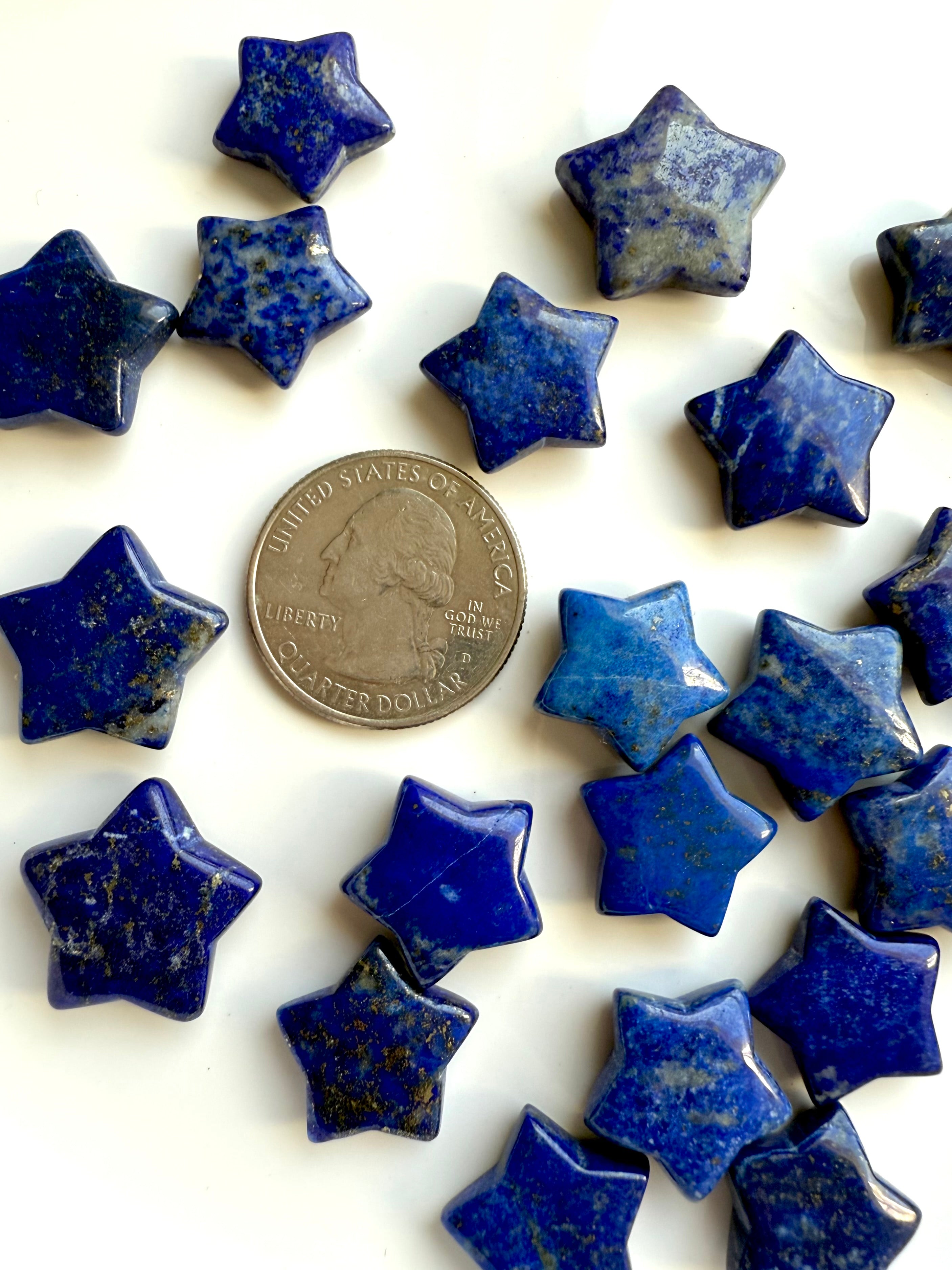 Close up of Mini Lapis Lazuli star carvings next to a US quarter for size comparison