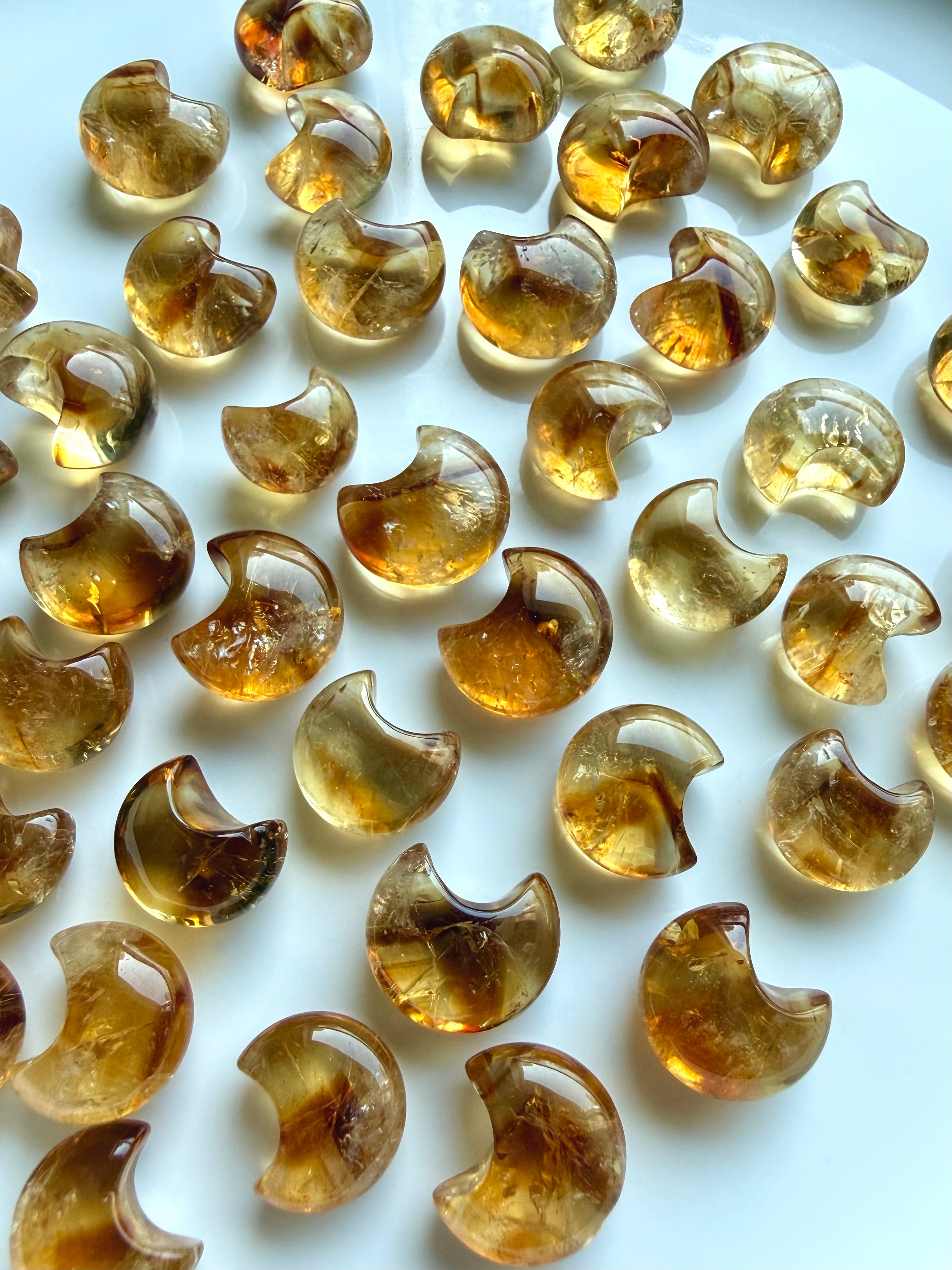 Translucent Citrine moon carvings with rich amber and golden honey color zoning and glossy polished surfaces