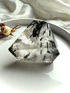 Protective Black Tourmaline in Quartz freeform crystal displayed for meditation and energy work