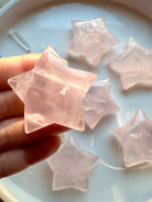 High-clarity Rose Quartz Star from Mozambique with soft translucence and natural inclusions — hand-carved pink crystal star shape.