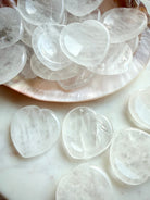 clear quartz heart worry stones close up showing natural inclusions and polished texture