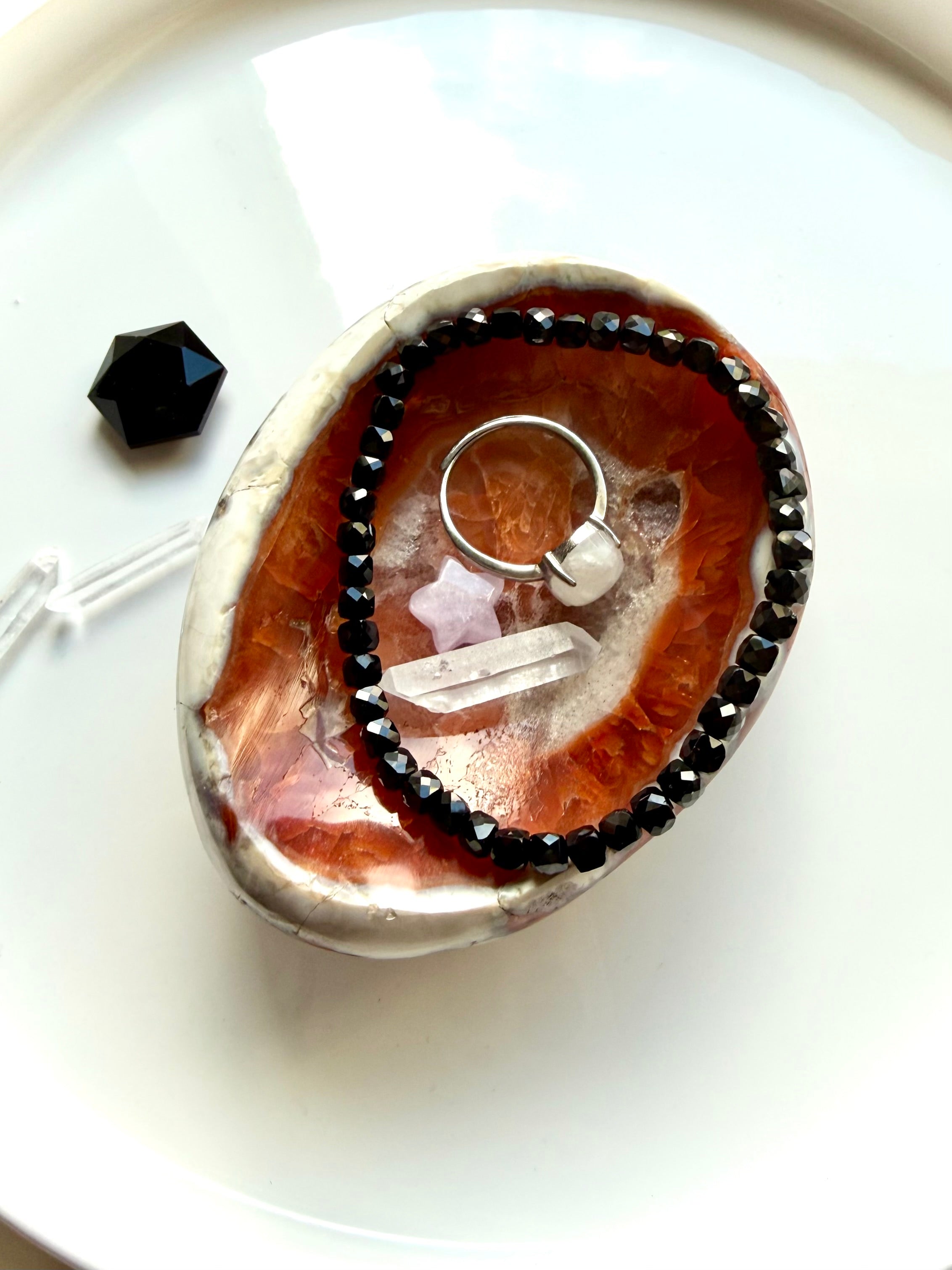 carnelian gemstone bowl used as ring dish with crystals and jewelry display