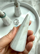 Marble jewelry cone stand in hand showing scale and beveled edges