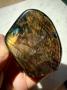 Polished Orange Labradorite freeform showing warm copper flash and angle-dependent color play