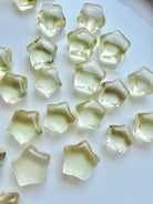 Mini Lemon Citrine stars in two sizes with clear lemon-yellow color and subtle natural crystalline patterns