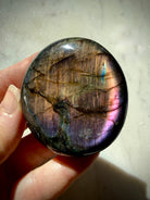 Rainbow Labradorite palm stone showing softer gold, green and violet labradorescence as the viewing angle changes