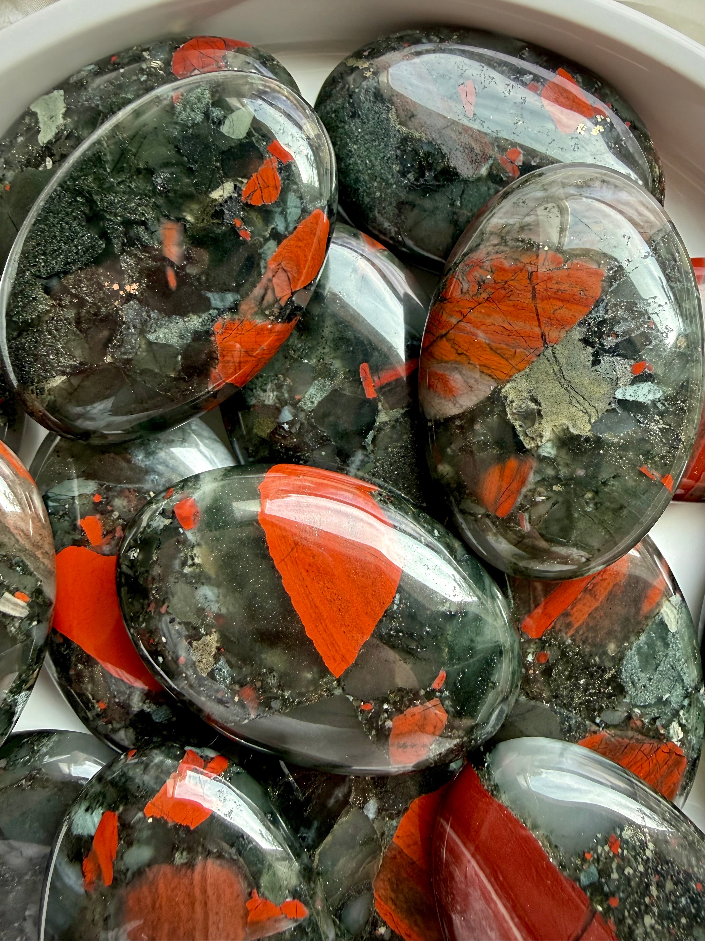 Natural Bloodstone Heliotrope palm stones showing vivid red inclusions, deep green tones and unique earthy patterns