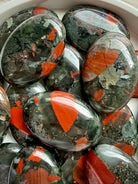 Natural Bloodstone Heliotrope palm stones showing vivid red inclusions, deep green tones and unique earthy patterns