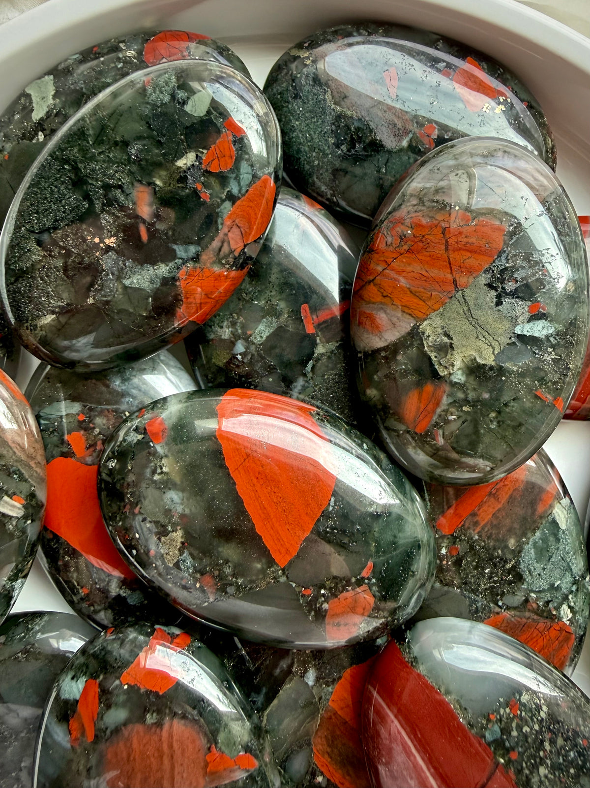Natural Bloodstone Heliotrope palm stones showing vivid red inclusions, deep green tones and unique earthy patterns