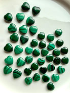 High-quality Mini Malachite crystal hearts on white with natural green banding and swirling patterns