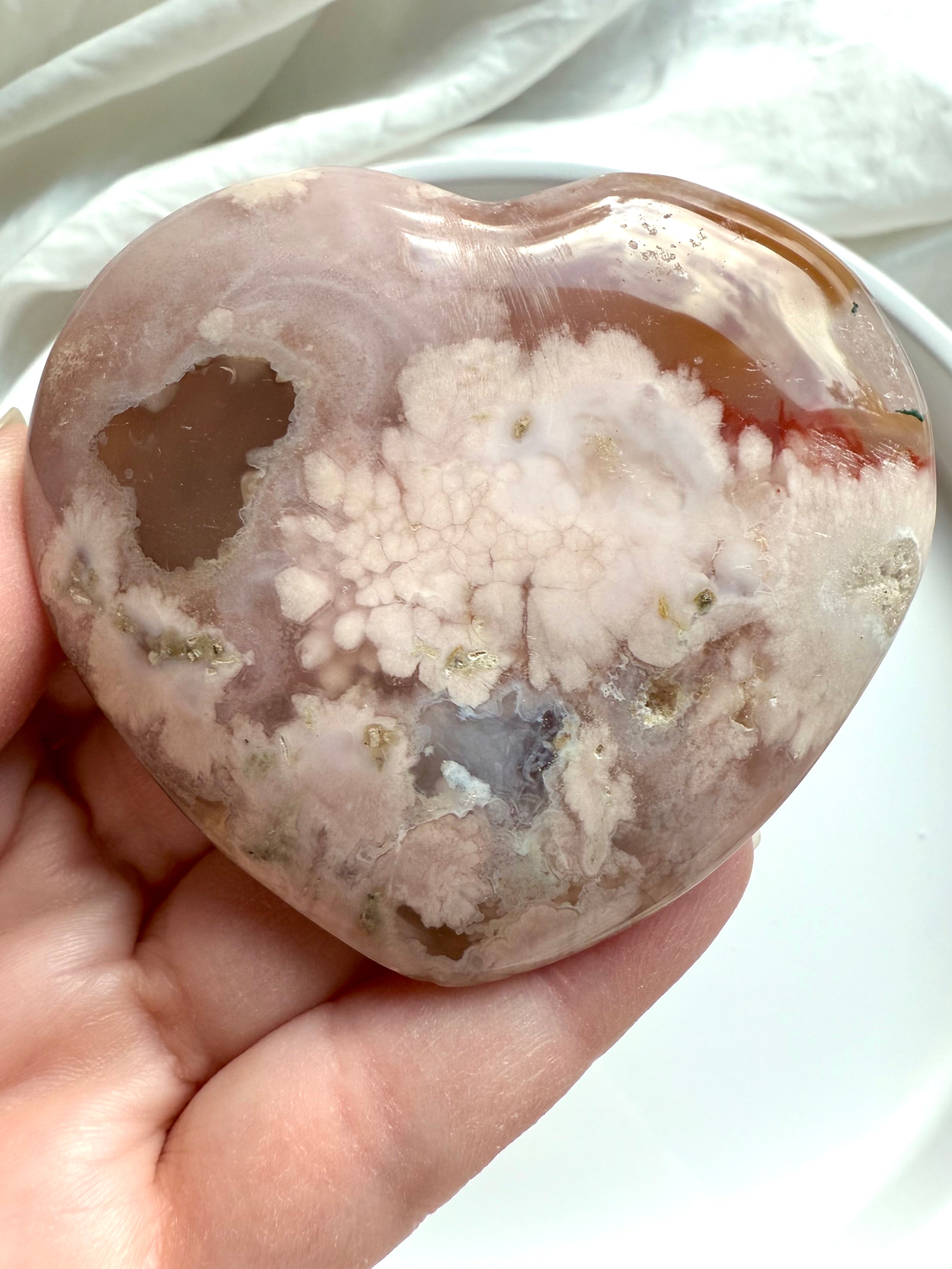 Close-up of Pink Amethyst Flower Agate Heart showing white crystalline bloom and deep carnelian pocket