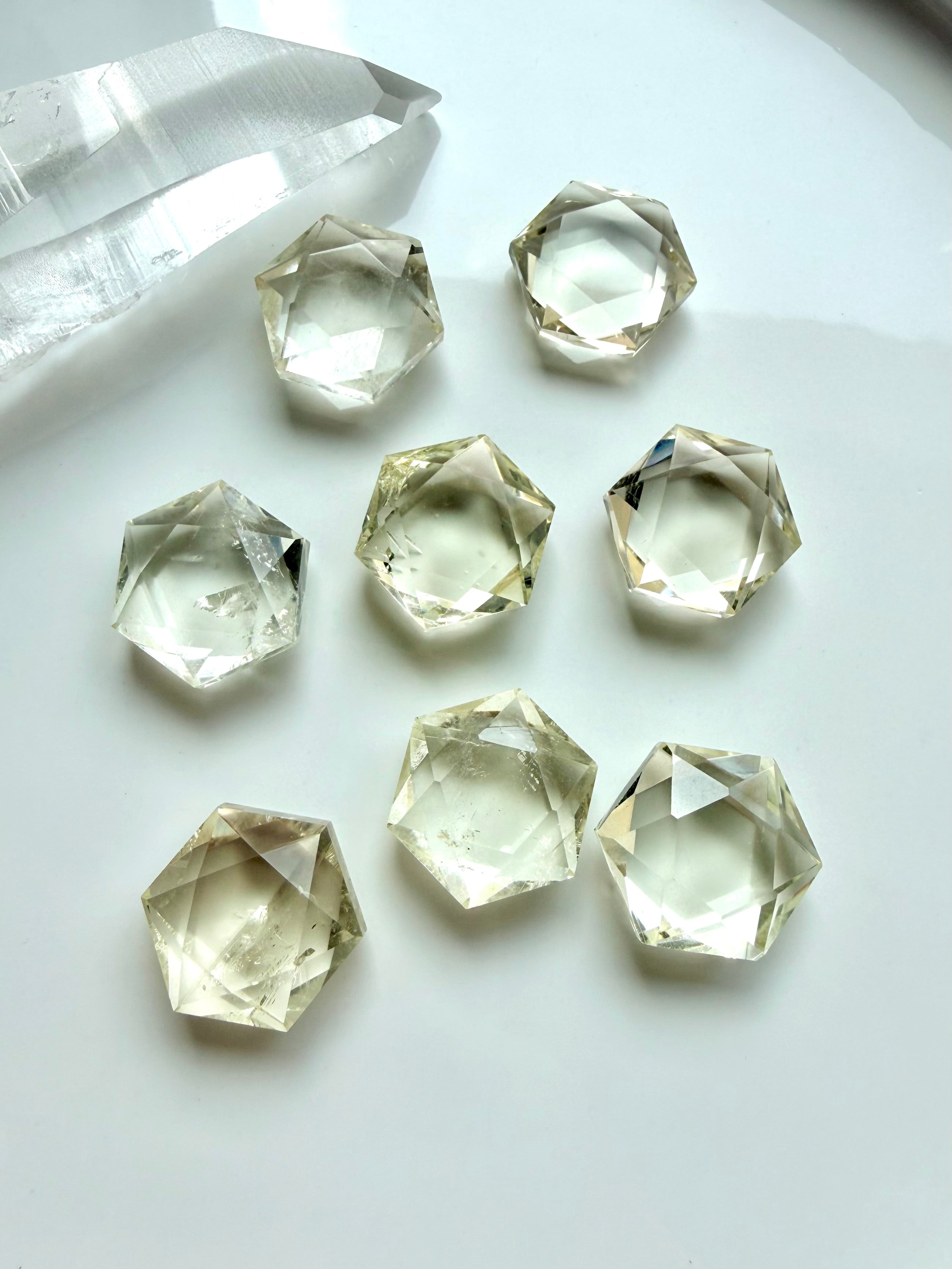 Mini Citrine hexagons with precision-cut facets, clear champagne-gold color, and light-catching internal patterns