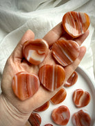Carnelian crystal heart worry stones with natural banding and grounding energy