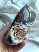Side view of Orca Agate offering bowl with contrasting polished agate and raw matrix — unique carved crystal bowl for grounding, protection, and sacred rituals.
