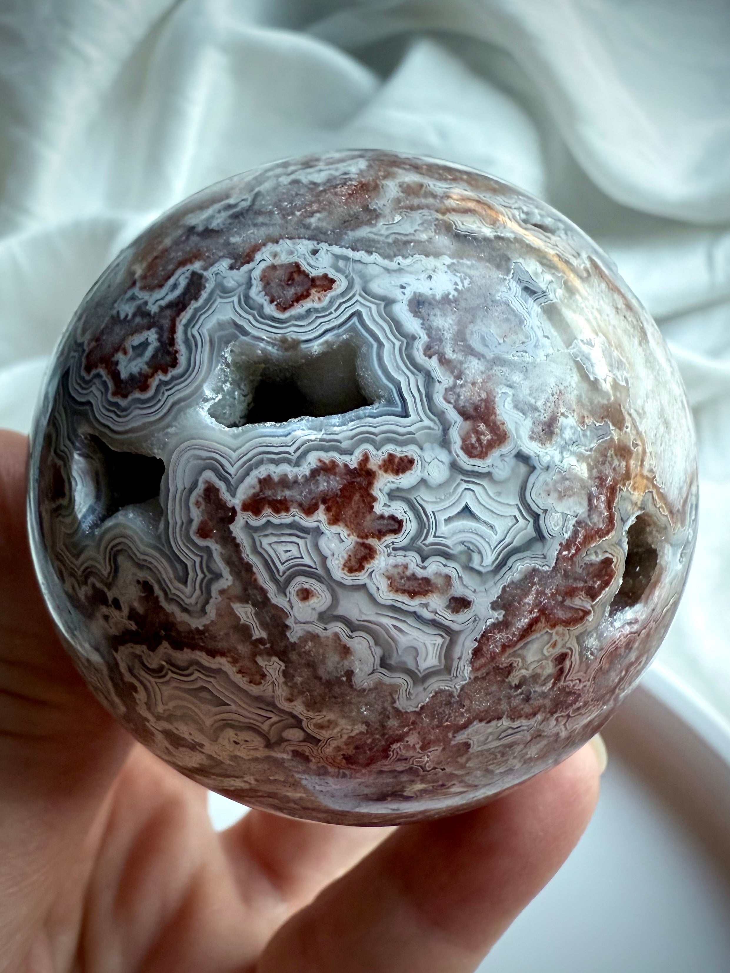 Crazy Lace Agate sphere with druzy pockets and intricate concentric banding for grounding energy