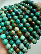 Stack of Chrysocolla Shattuckite bracelets showing earthy turquoise, blue, and brown gemstone beads for wisdom and communication