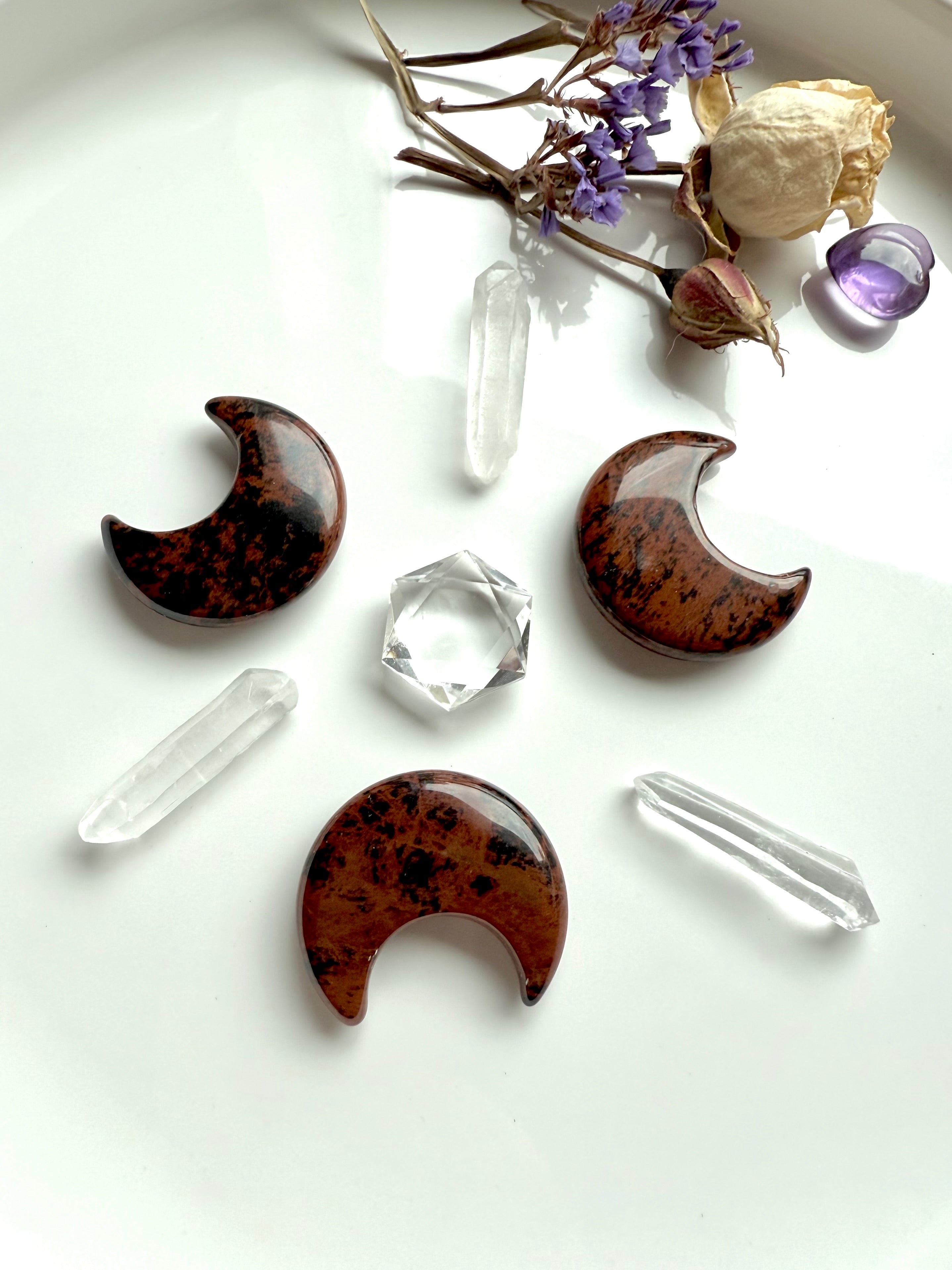 A protection crystal grid with Mahogany Obsidian crescent moons & clear quartz hexagon center. Root & Sacral Chakra grid for grounding and renewal.