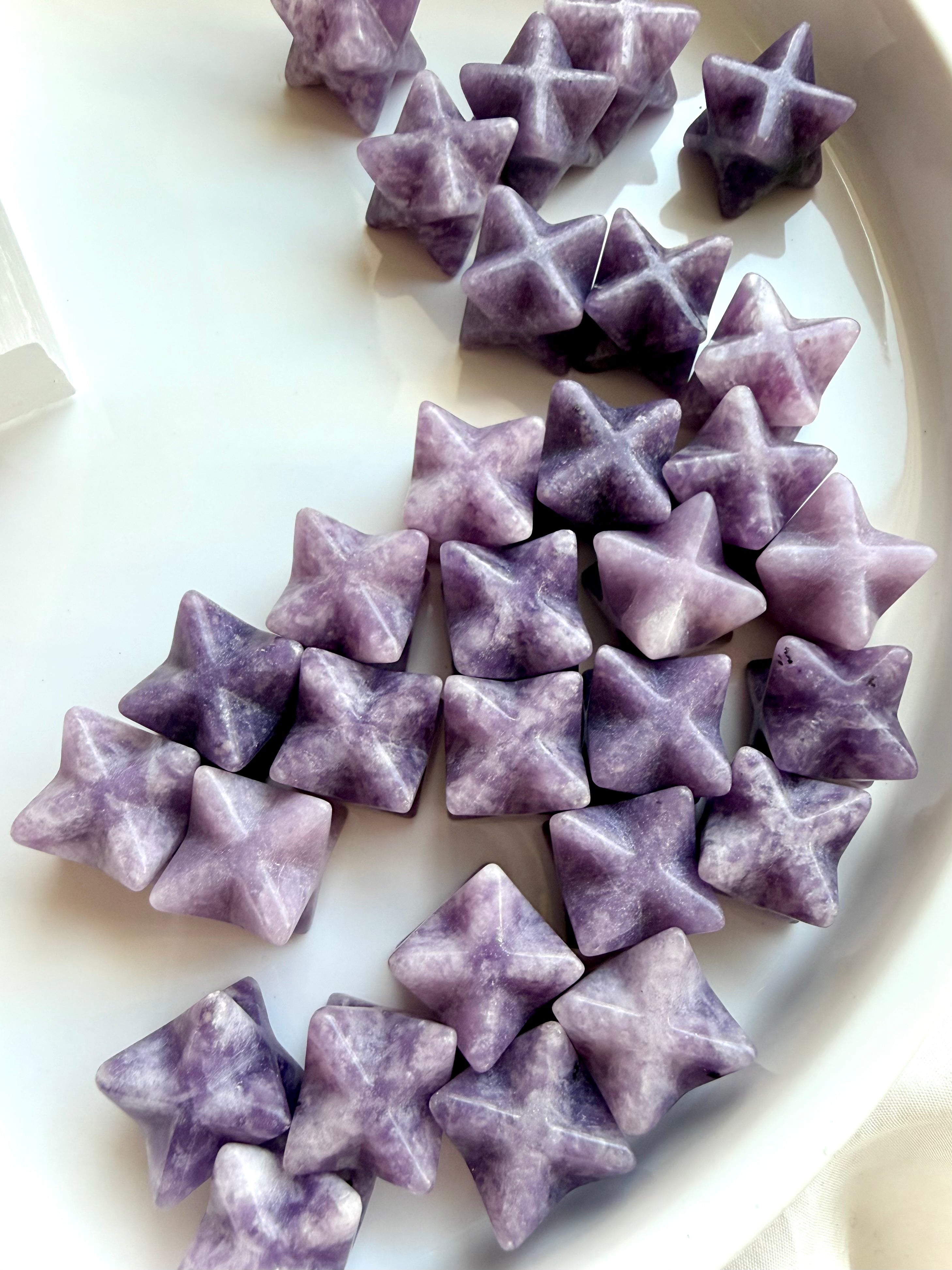 group of lepidolite merkaba stars with natural lilac tones and mica sparkle, crystals for sleep, relaxation and balance