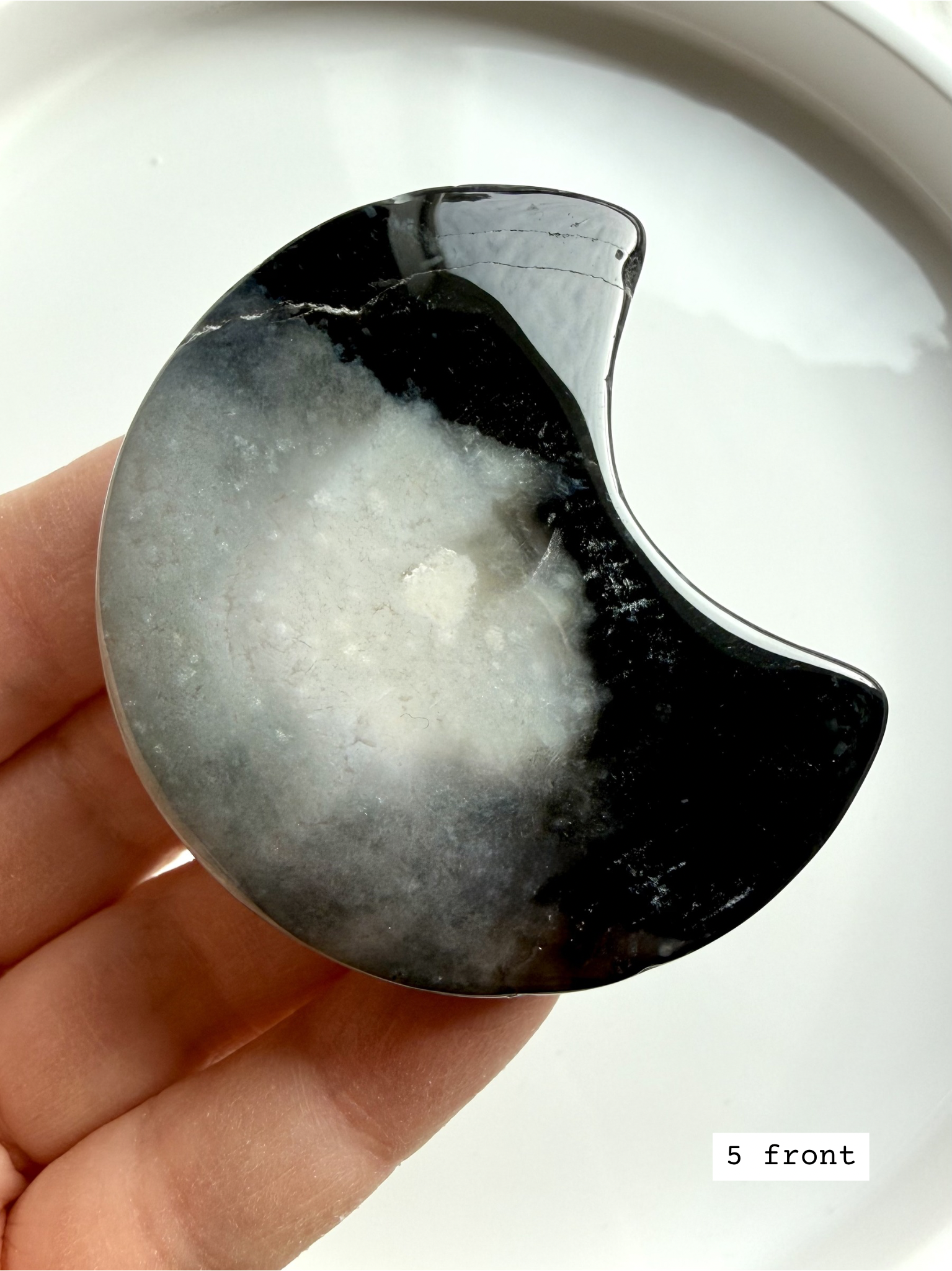 black flower agate moon carving #5 front showing crescent shape with flowing floral plume patterns