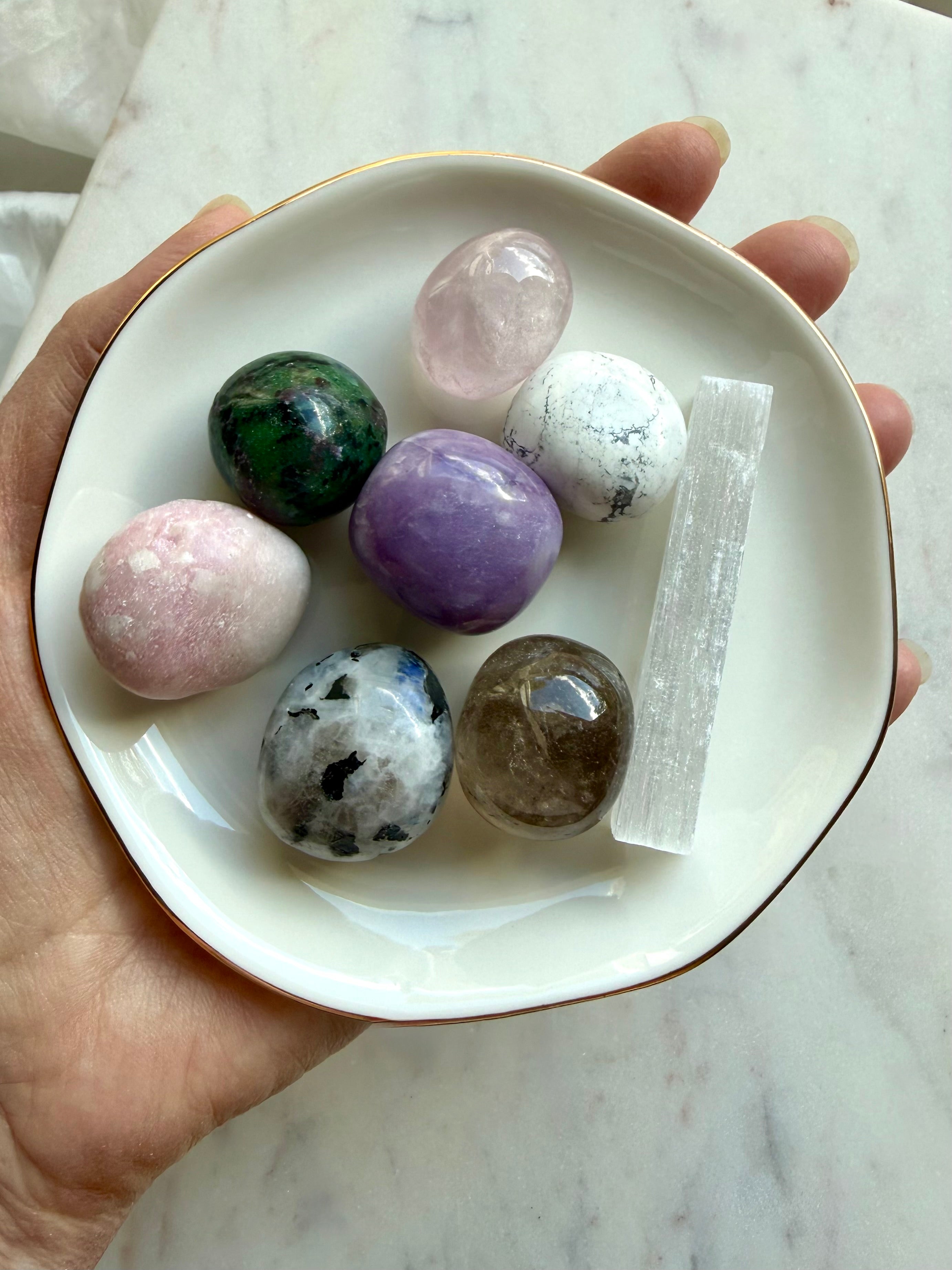 Grief support crystal set with Rose Quartz, Amethyst, Moonstone, Howlite, Smoky Quartz, and Selenite in a gold rim ceramic bowl