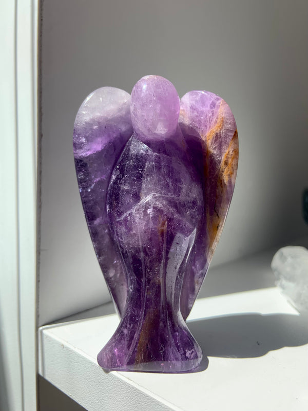 A beautiful hand carved purple Amethyst Angel Figurine with with Golden Healer inclusions to elevate your sacred space. Crystal angels make really special one of a kind gifts as well.