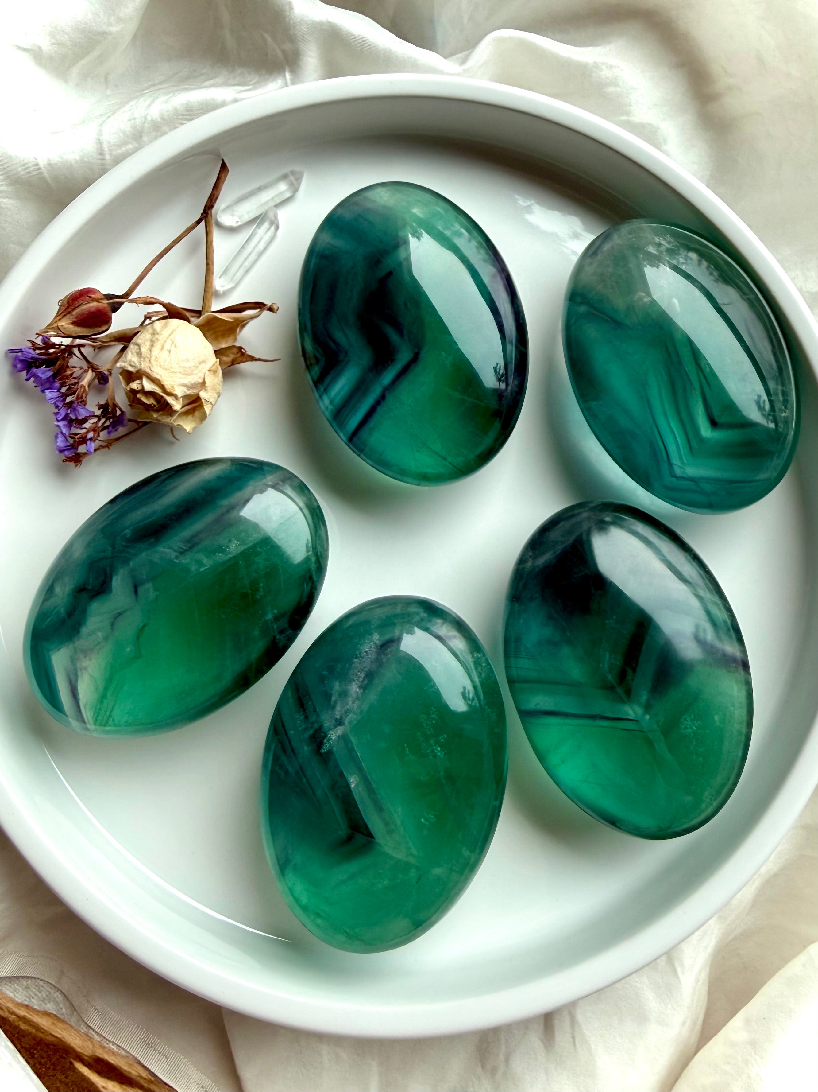 Large Teal Fluorite palm stones with vibrant blue green banding and luminous translucency for clarity and focus