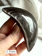 Handheld Silver Sheen Obsidian moon carving showing reflective silver sheen, crystal for intuition and energetic protection