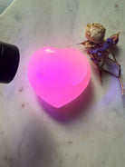 UV fluorescent Mangano Calcite heart crystal from Pakistan glowing vivid pink under UV light 