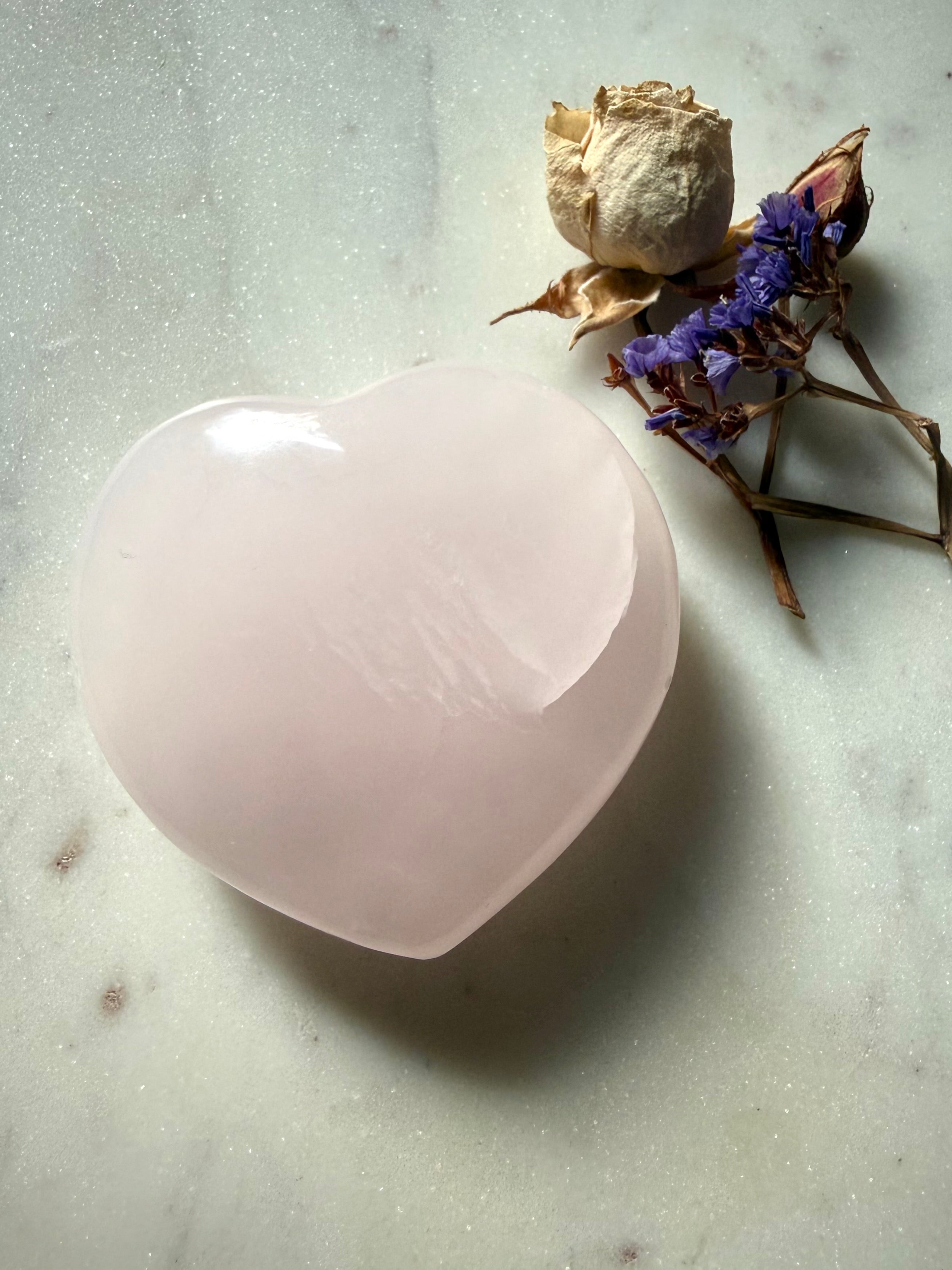 Mangano Calcite heart crystal showing soft internal cloud formations and delicate translucent pink color