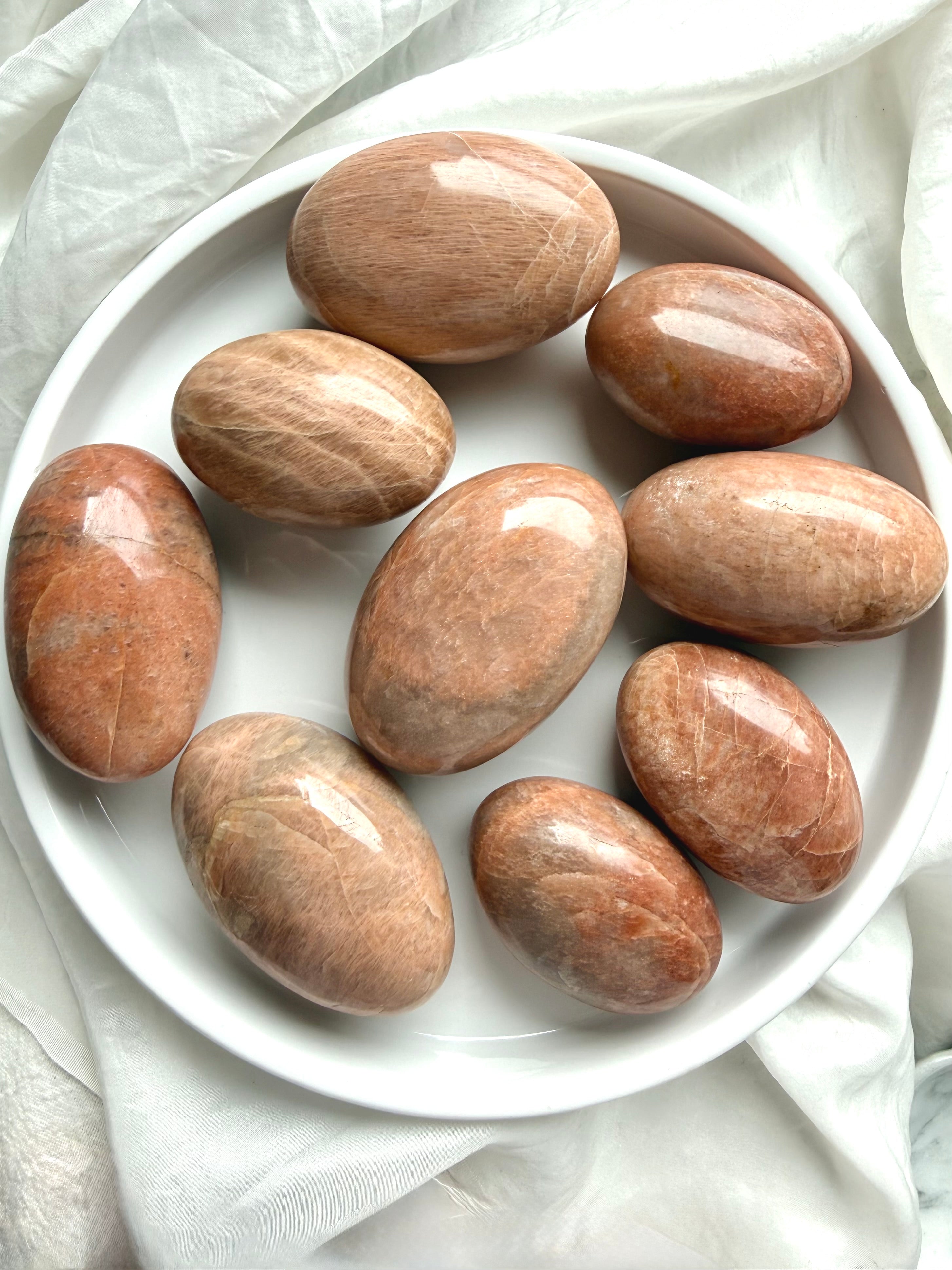Large Peach Moonstone palm stones with glossy polished finish and natural peach orange coloring