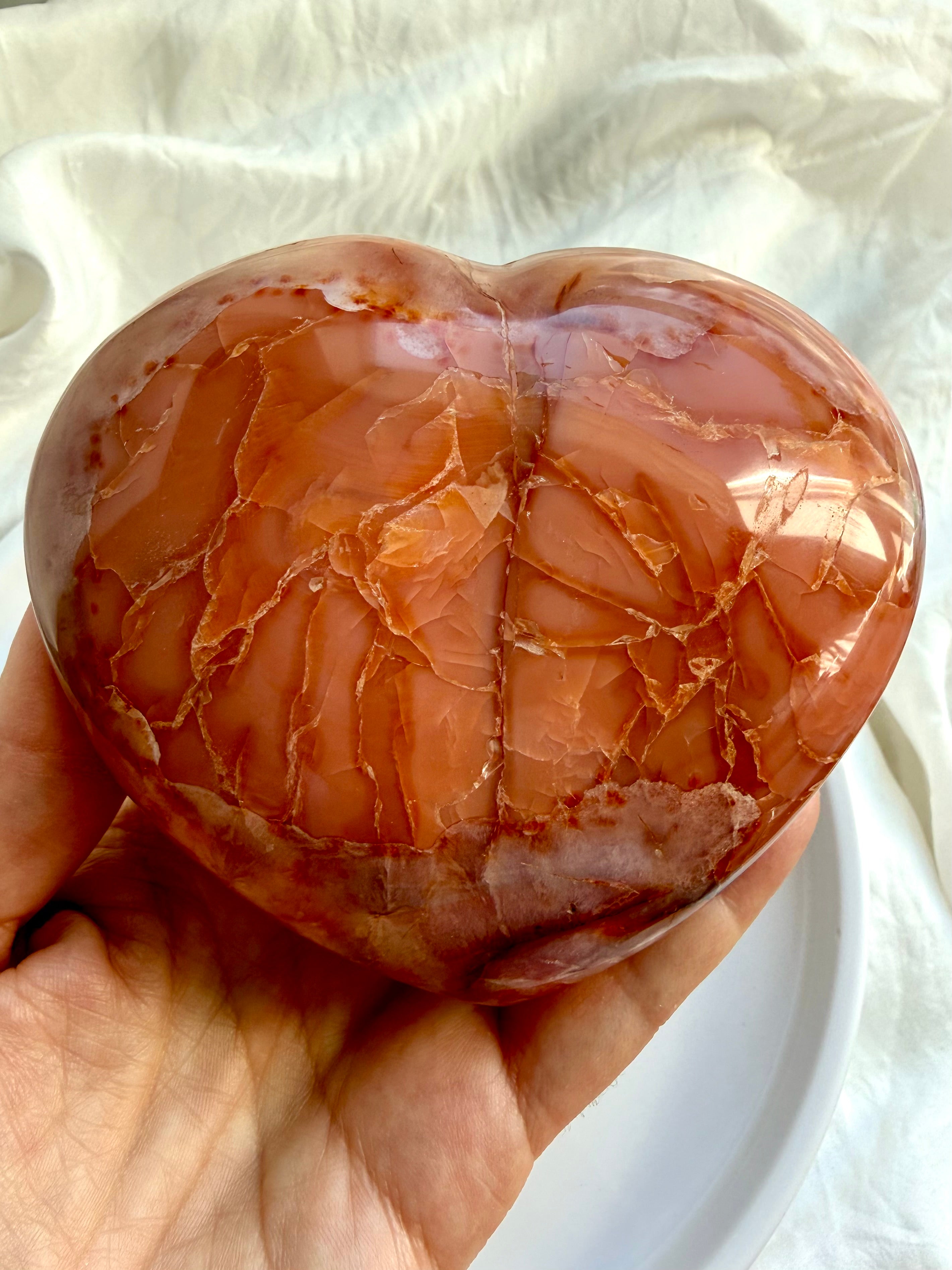 Back angle of one of a kind Carnelian geode heart showing natural color variation and banding
