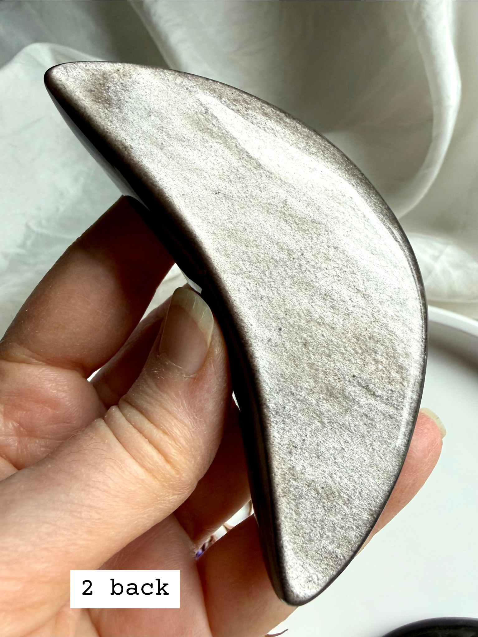 Polished Silver Sheen Obsidian crescent moon back view, grounding stone for shadow work and energetic balance