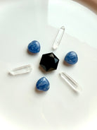 Mini Blue Kyanite heart crystals arranged in a crystal grid pattern with quartz and obsidian for throat chakra alignment, communication and energy flow