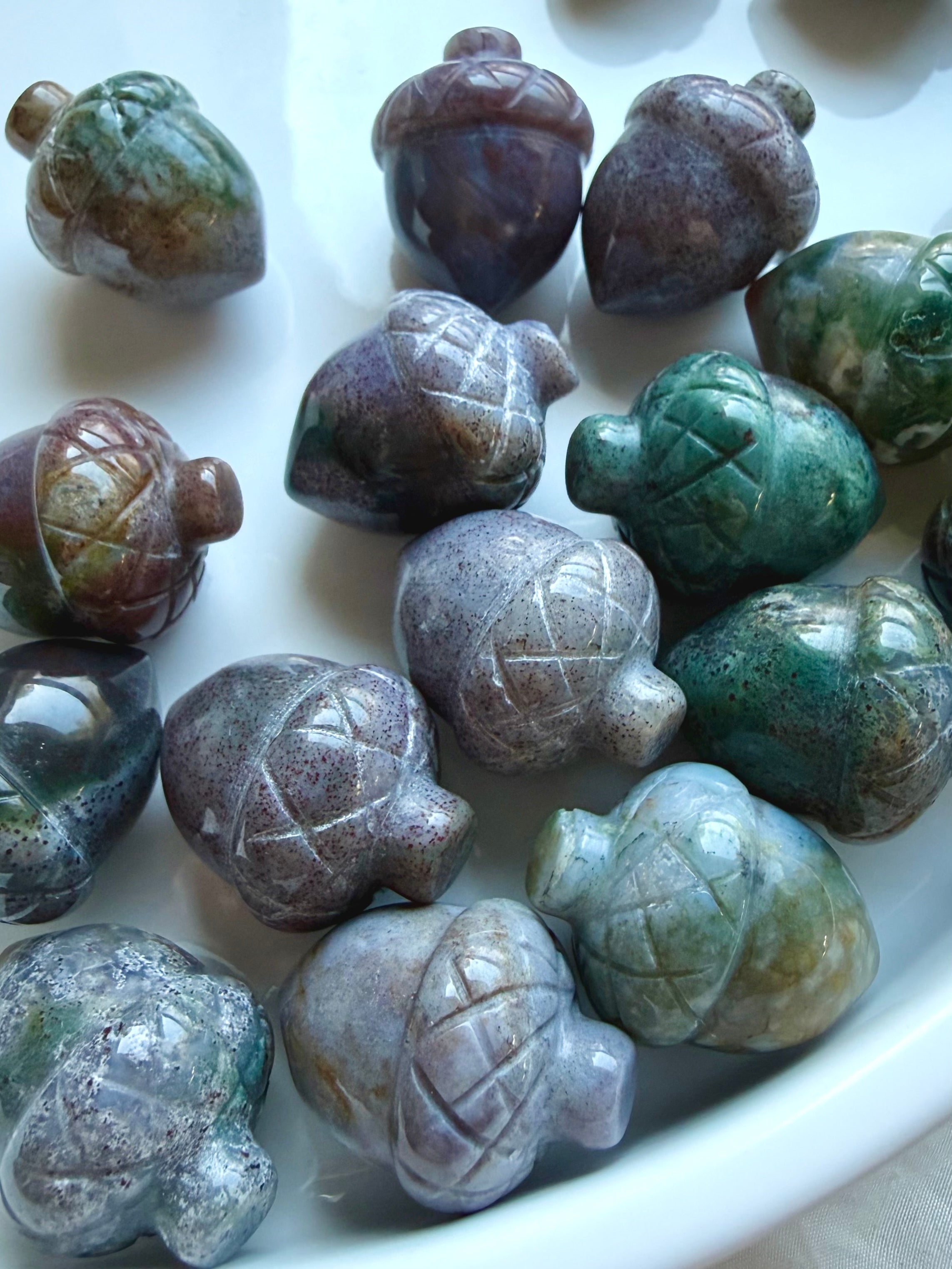 Closeup of mini Ocean Jasper crystal acorns in assorted teal, lavender, green and earthy tones 