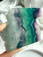 Close-up of natural fluorite slab showing layered color zoning and polished crystal surface