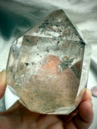 A polished Garden Quartz Crystal with a big phantom pyramid, green chlorite phantom lines + rainbows