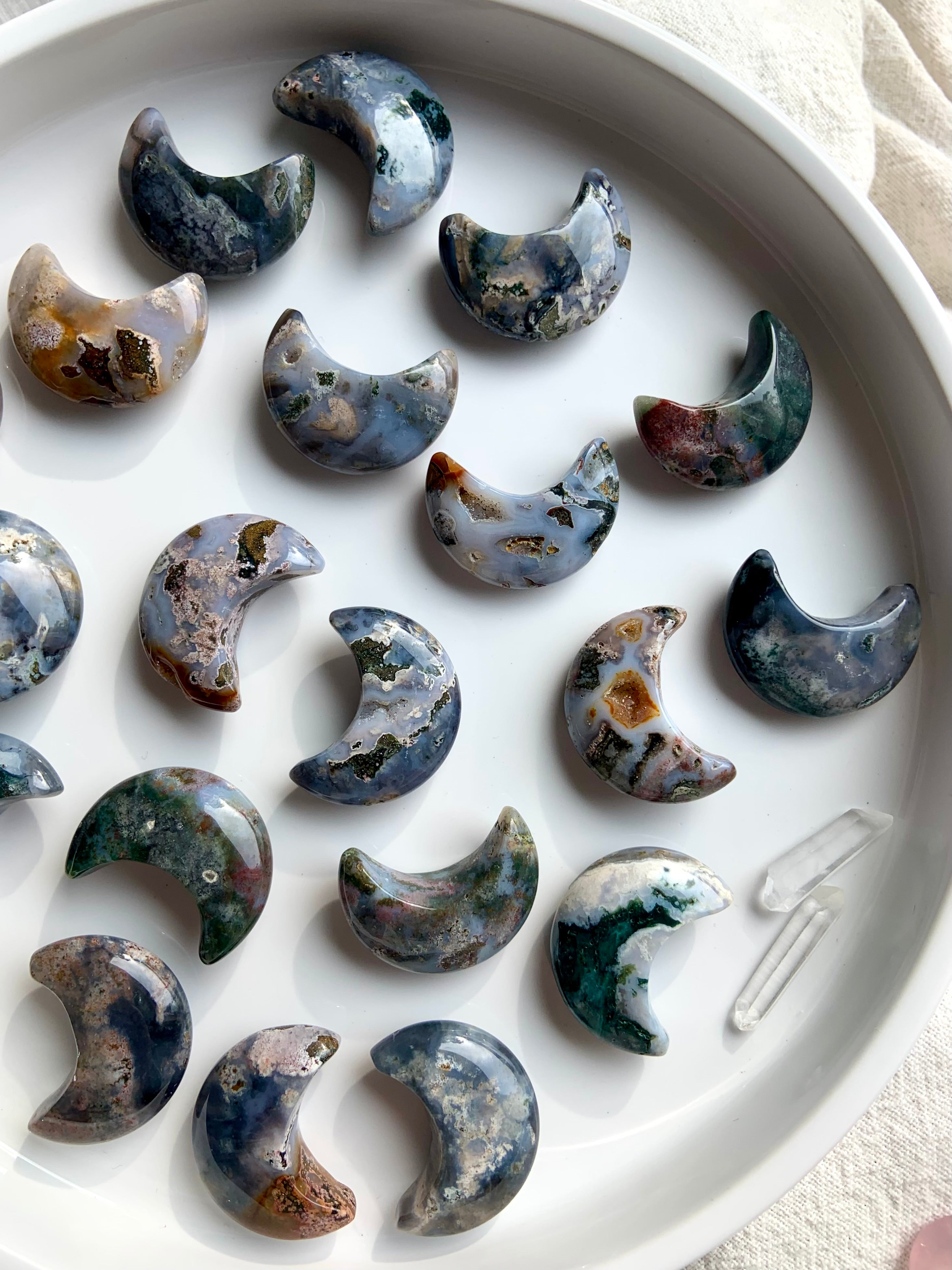 Cosmic Ocean Jasper moons crystal carvings on white background